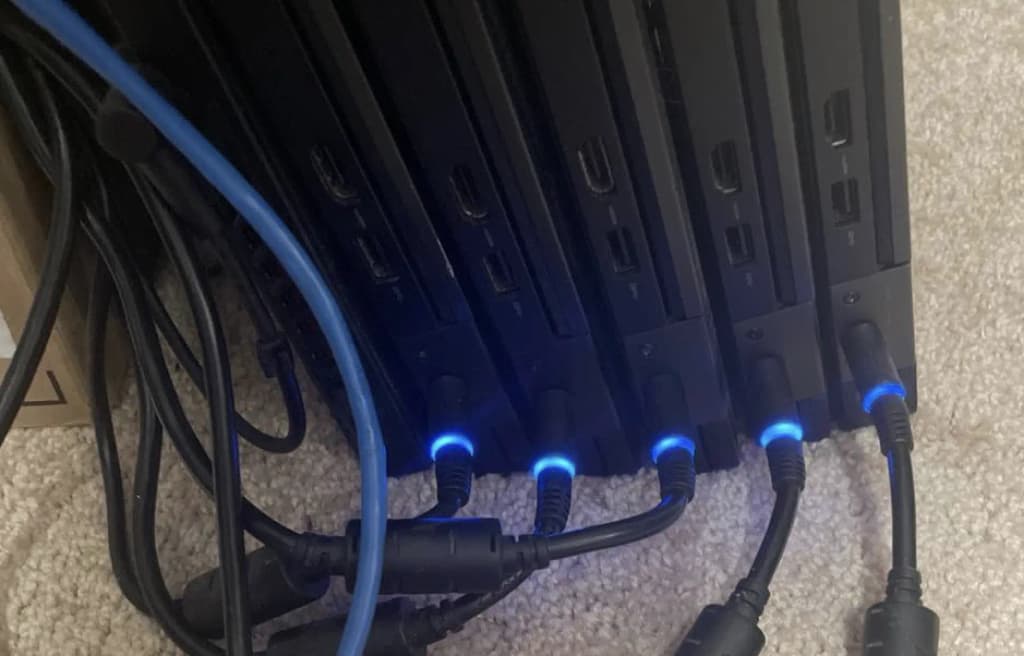 A toddler holding a blue laptop power plug she pulled from the home Kubernetes cluster
